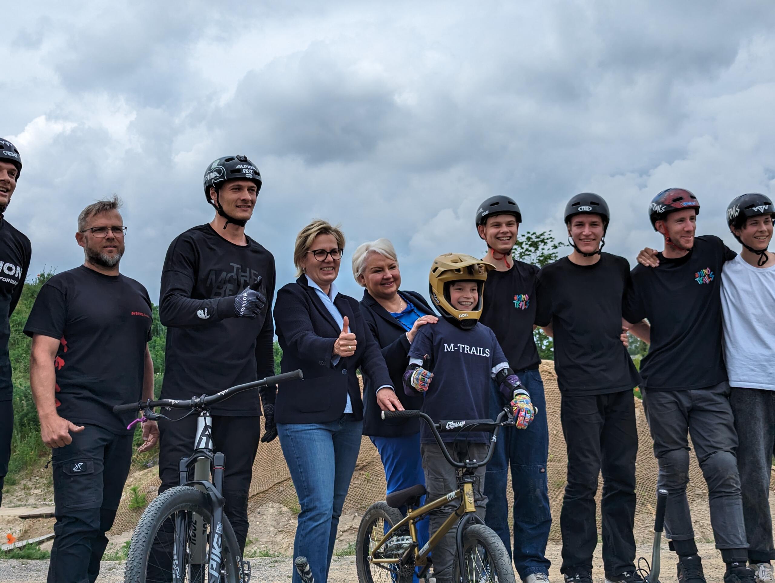 Tim und Lukas Knopf, Staatsministerin Barbara Klepsch, Bad Dübens Oberbürgermeisterin Astrid Münster, Niels Gehrke und weitere Akteure bei der Eröffnung der Pumptrack- und Dirtanlage in Bad Düben